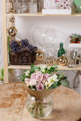 glass vase with Mixed bouquet on wood table. beautiful fresh flowers still life.