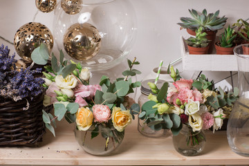 glass vase with Mixed bouquet on wood table. beautiful fresh flowers still life.
