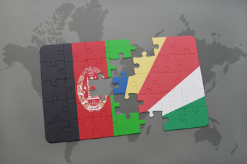 puzzle with the national flag of afghanistan and seychelles on a world map background.