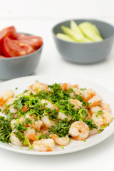 Fried shrimps with the greens. Easy seafood snack with fresh vegetables.  