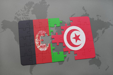 puzzle with the national flag of afghanistan and tunisia on a world map background.