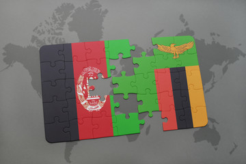 puzzle with the national flag of afghanistan and zambia on a world map background.