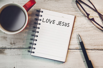 Love Jesus text on notebook