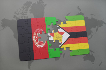 puzzle with the national flag of afghanistan and zimbabwe on a world map background.