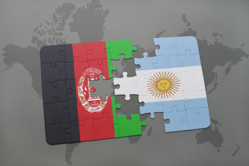 puzzle with the national flag of afghanistan and argentina on a world map background.