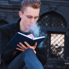 young student smoking and preparing for the exam in old center o
