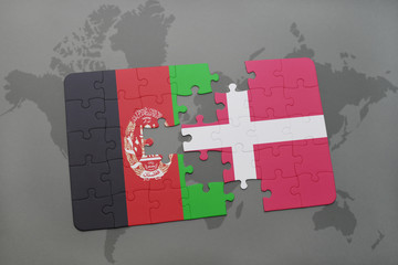 puzzle with the national flag of afghanistan and denmark on a world map background.