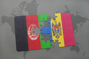 puzzle with the national flag of afghanistan and moldova on a world map background.