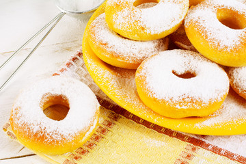Donuts with caster sugar on checkered napkin