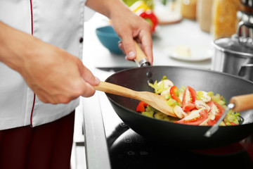 Mixing vegetables in pan closeup