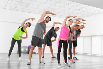 Group of people practicing yoga in a gym