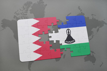 puzzle with the national flag of bahrain and lesotho on a world map background.