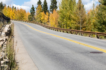 Road with guard rail and autumn color in Colorado