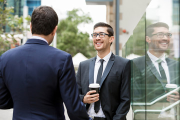 Two businessmen talking outdoors