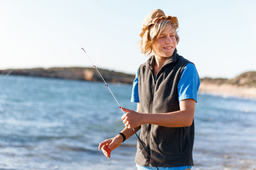 Teenage boy fishing at sea