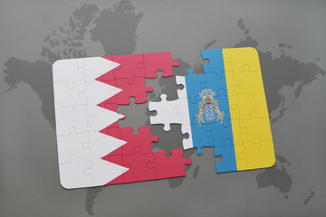 puzzle with the national flag of bahrain and canary islands on a world map background.