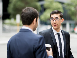 Two businessmen talking outdoors