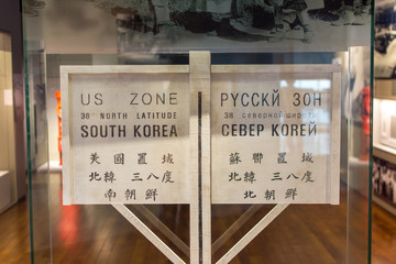 Sign of 38th north latitude between south and north korea which is written in Chinese, English,...