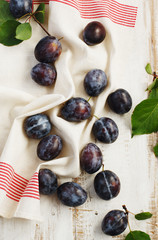Fresh plums with leaves