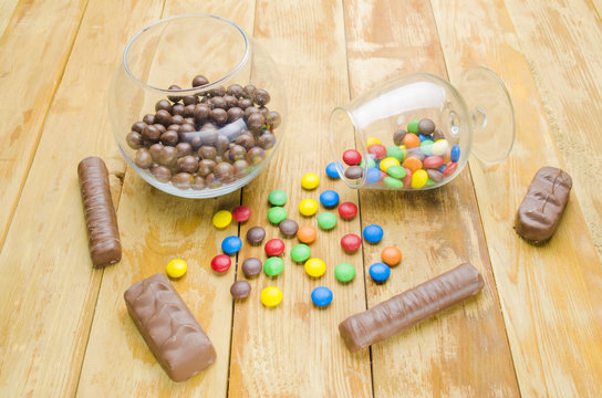multi-colored candies on a wooden background