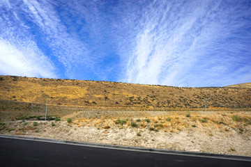 desert hill with blue sky and clouds