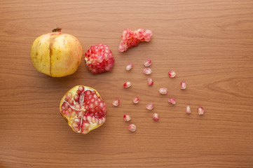 Fototapeta na wymiar Ripe pomegranate fruit on wooden background