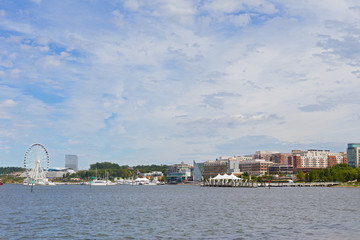 Waterfront panorama of National Harbor in Maryland, USA. Boats and yachts at National Harbor pier on a bright sunny day. - 121311296