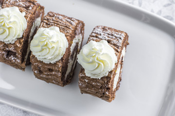 Detailed Top View on Chocolate roulade filled with whipped cream