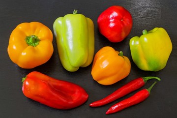 a variety of peppers on a dark background