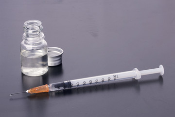 Substance abuse!. One syringe and a mysterious vial on a dirty table. Self-medication. Health...
