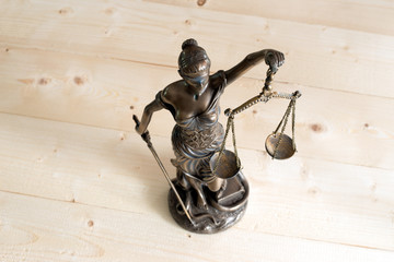 Lady Justice or Themis on wooden table