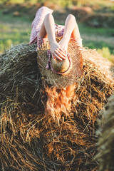 Beautiful woman on a haystack