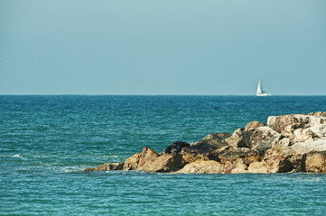 the seashore with waves breaking on the rock