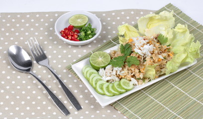 Fried rice with crab topped streamed crab,halve green lemon,sliced cucumber,lettuce and coriander  served  spicy  sour filling side dish. Side view.