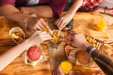 People Group Friends Hands Eating Fast Food Burgers Potato Drinking Orange Juice