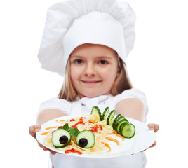 Little chef presenting a plate of pasta