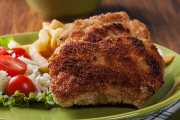 Cutlet Cordon Bleu with pork loin served with French fries and salad
