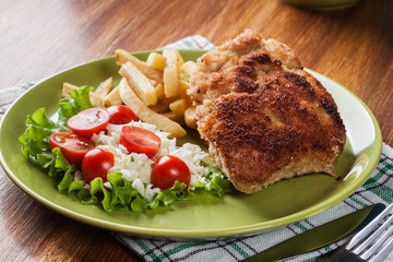 Cutlet Cordon Bleu with pork loin served with French fries and salad