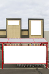 Mock up. Supermarket or store billboard and shoping trolley bay in a parking lot.