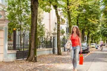 Fototapeta na wymiar Shopping woman walking though avenues