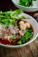asian noodle soup with beef meatball with fresh vegetable on woo