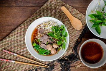asian noodle soup with beef meatball with fresh vegetable on woo