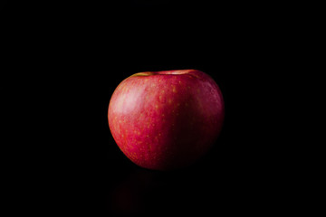 fresh red apple fruit over black background