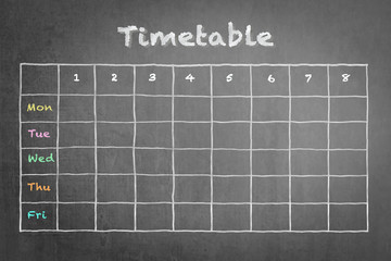 Timetable schedule on black chalkboard background