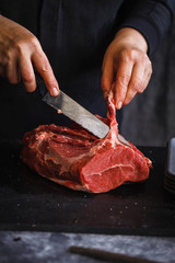 Fresh beef butcher meat cutting with knife.