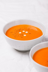 Homemade vegetable cream soup with bread on a bright background, closeup