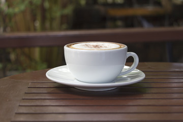 hot coffee and white cup on wood table