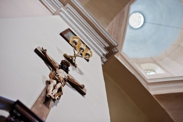 Wooden crucifix of Jesus Christ at wall on church