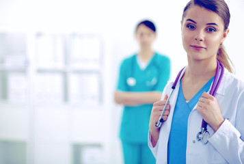 Woman doctor standing with stethoscope at hospital