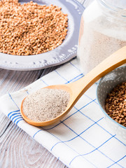 Buckwheat grain and flour. Vertical